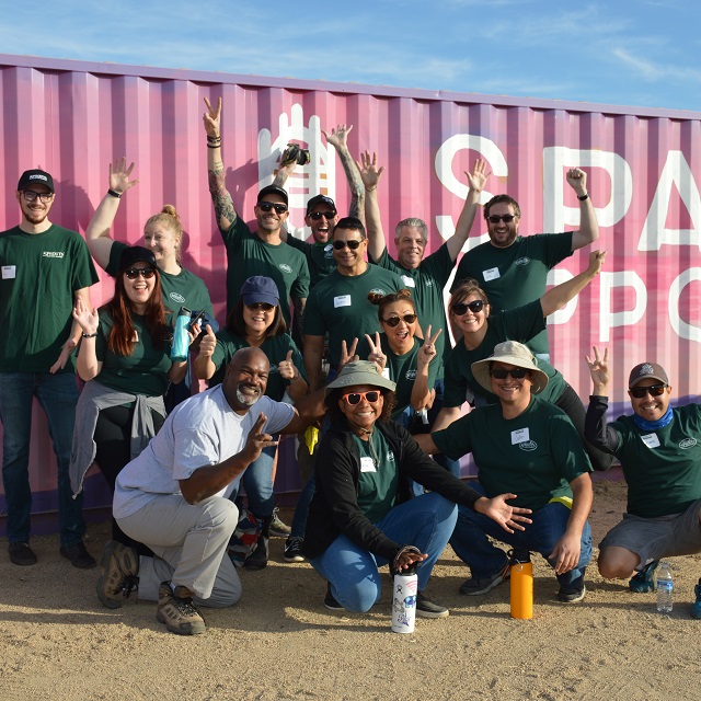Sprouts team members volunteering at a garden