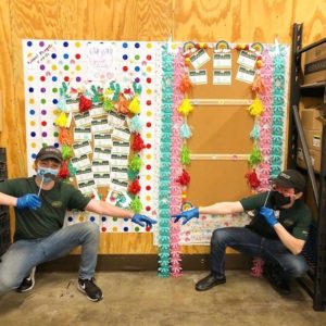 Sprouts team members in front of a display board of comment cards