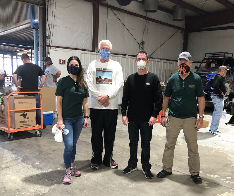Four volunteers at distribution center warehouse