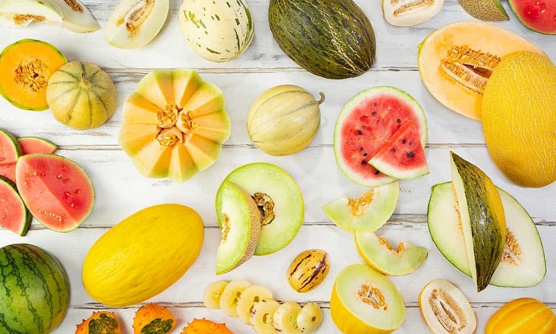 Melons on white wood background