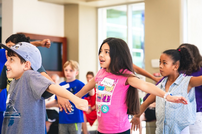 Kids participate in a dance class.