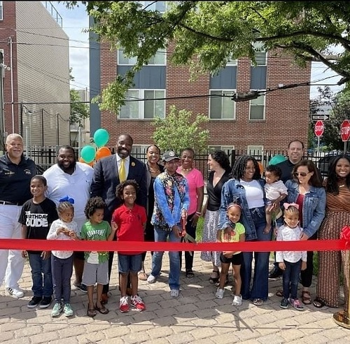 A group of people celebrate the ribbon cutting at the Concert Garden in Philadelphia