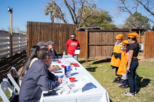 Elementary-aged chefs present their recipes to a panel of judges.