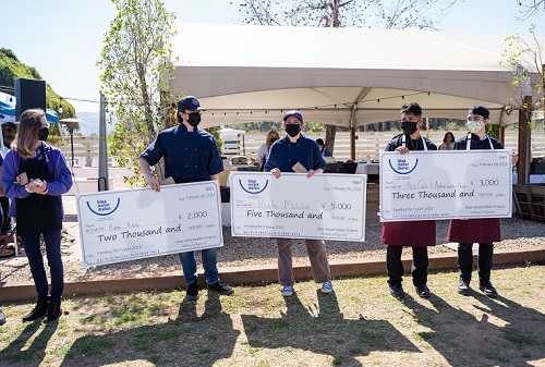 Competition winners proudly hold their jumbo checks.