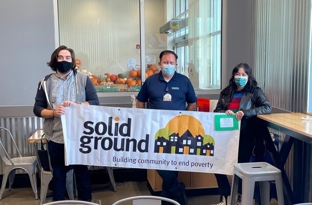The nonprofit, Solid Ground, receives a grant check from a Sprouts store manager.