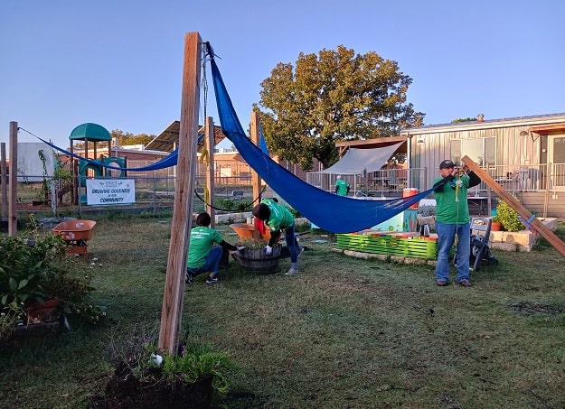 Volunteers install a shade sail at a school in Austin, Texas.